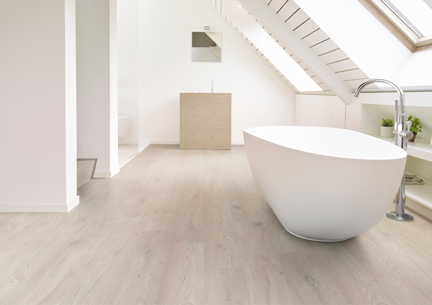 luxury vinyl flooring in bathroom with bath tub.